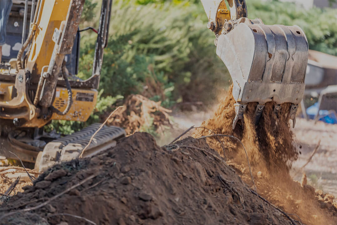 Excavator Moving Dirt and Debris