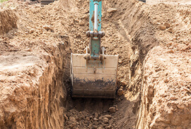 Excavator Digging Trench for Drainage Pipes