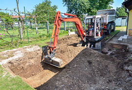 Excavator Removing a Backyard for a New Patio