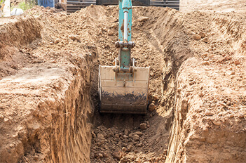 Excavator Digging A Sewage Trench